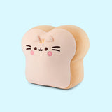 Side quarter view of the Pusheen White Bread Squisheen. Pusheen's eyes, mouth, and whiskers are embroidered in dark brown. Pusheen has a light pink color blush circles under her eyes. Between the two triangular 3D ears are Pusheen's classic 3-stripes in a light cream thread color.