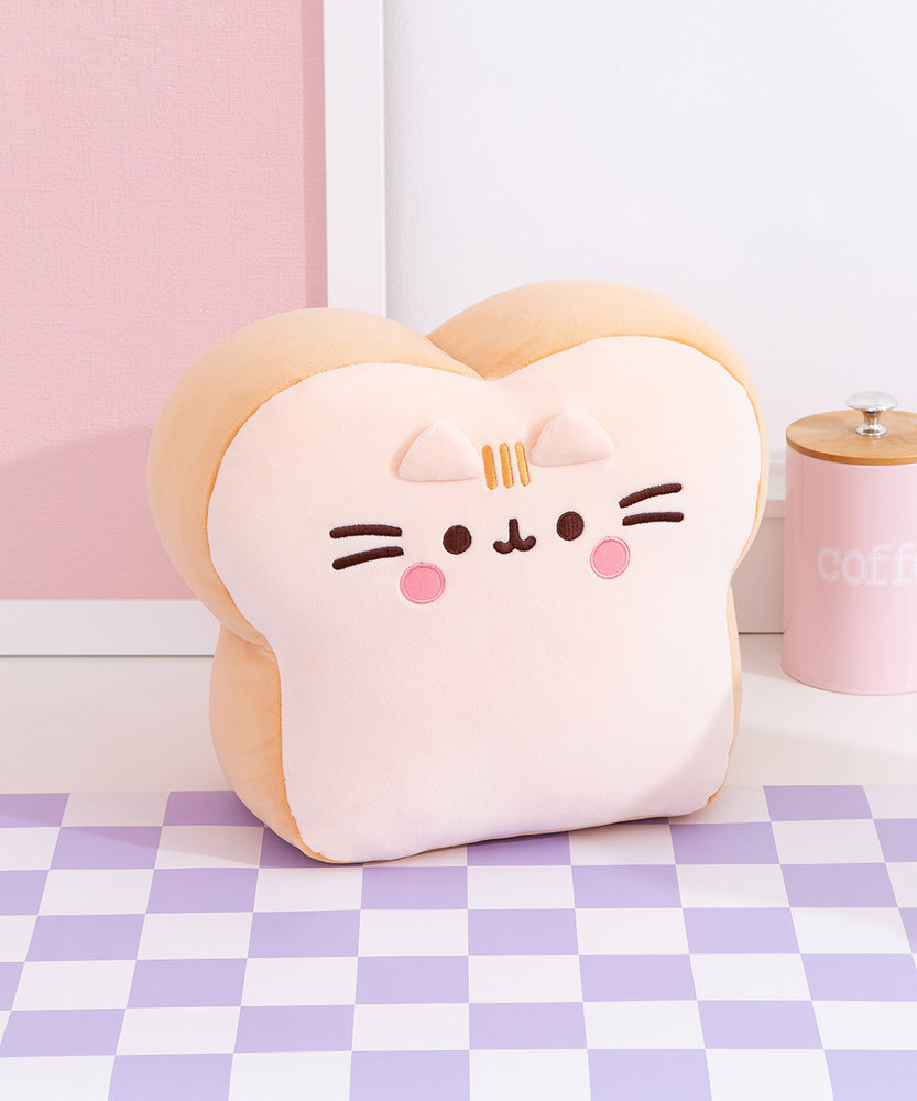 Side quarter view of the Bread Plush. The edges of the plush are a light brown color while the front and back of the plush is a light cream color to mimic the look of a slice of white bread.