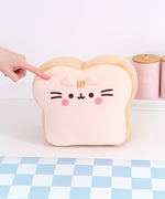 Front view of the Pusheen's Kitchen White Bread Squisheen Plush. The white bread loaf plush features Pusheen as a slice of bread with rounded top corners and a square bottom.