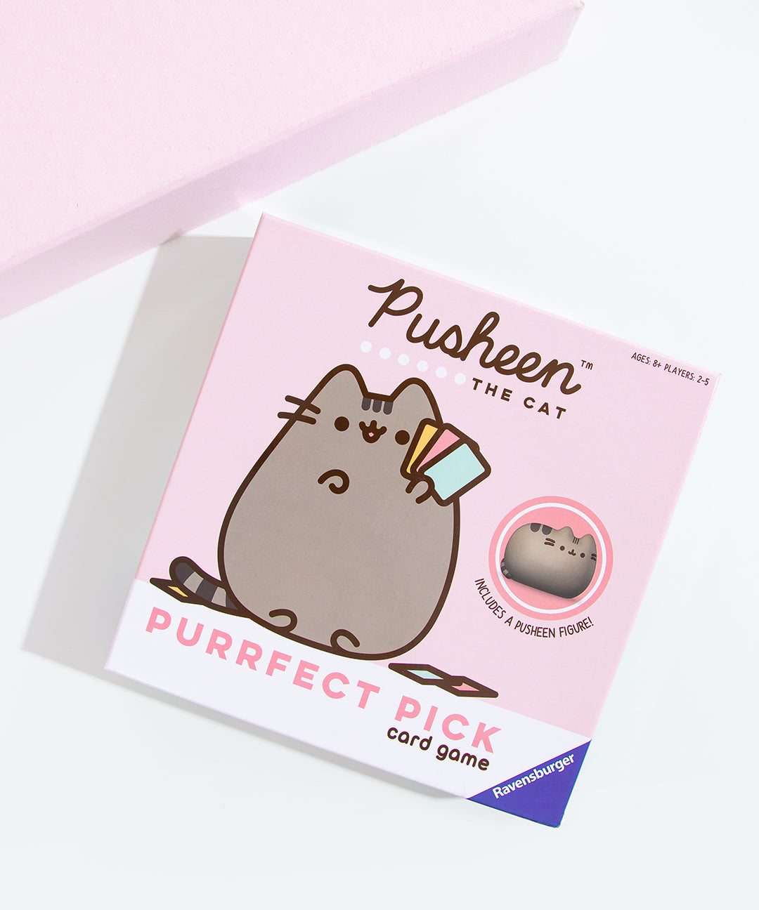 Packaging box containing the Pusheen Purrfect Pick Card Game by Ravensburger. The front packaging notes that a mini Pusheen figure is included in the game. 