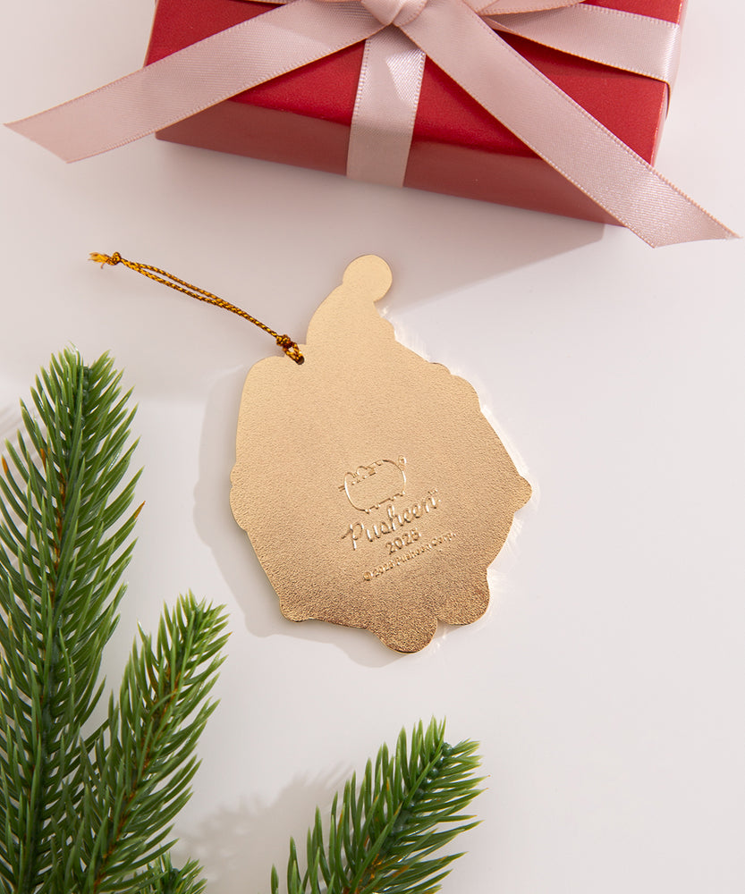 Back view of the ornament, which is a solid gold. The design on the back is the Pusheen the Cat logo, the copyright information, and the year 2025.