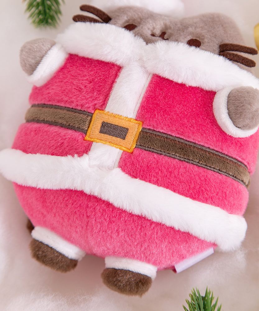 Close-up of Santa Costume on the Pusheen Plush. The classic red and white suit is accented with black boots and a black and gold belt.