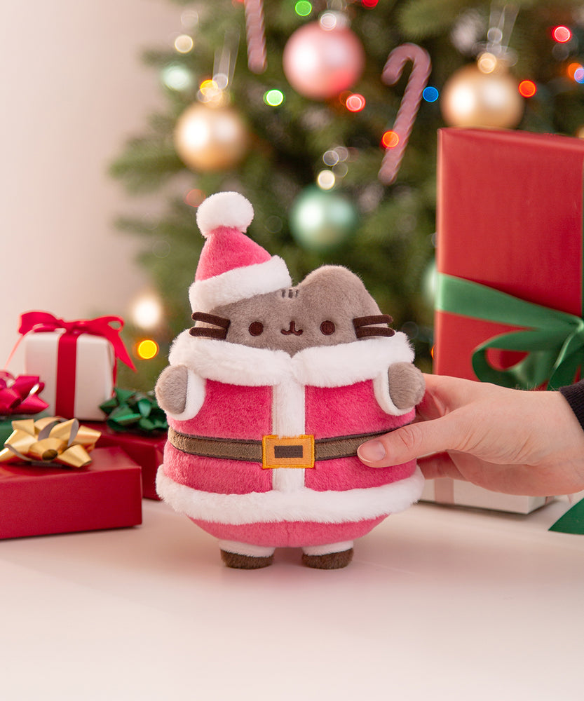 Model holds Santa Paws Plush to demonstrate size and scale of the standing plush.