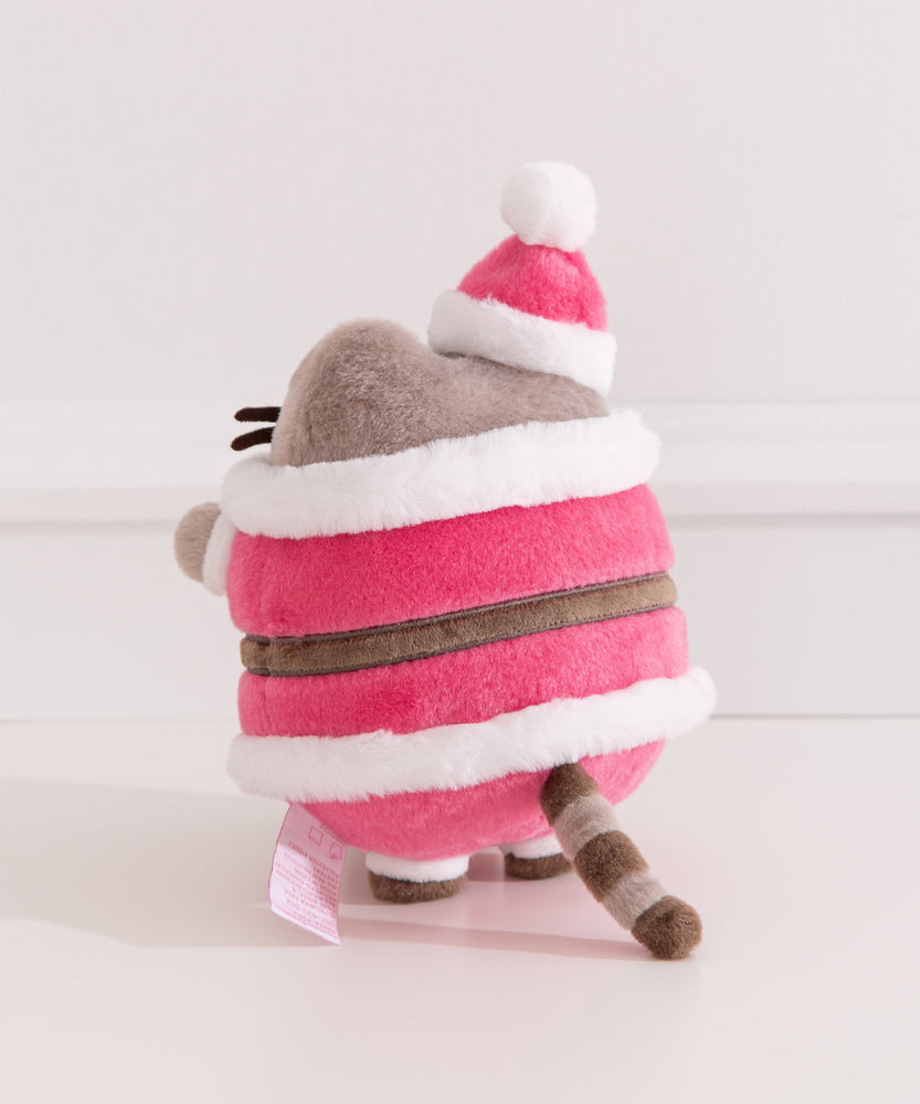 Side and back view of the Santa Claus Pusheen Plush. Coming out of the back of the plush is Pusheen's classic gray and brown striped tail.