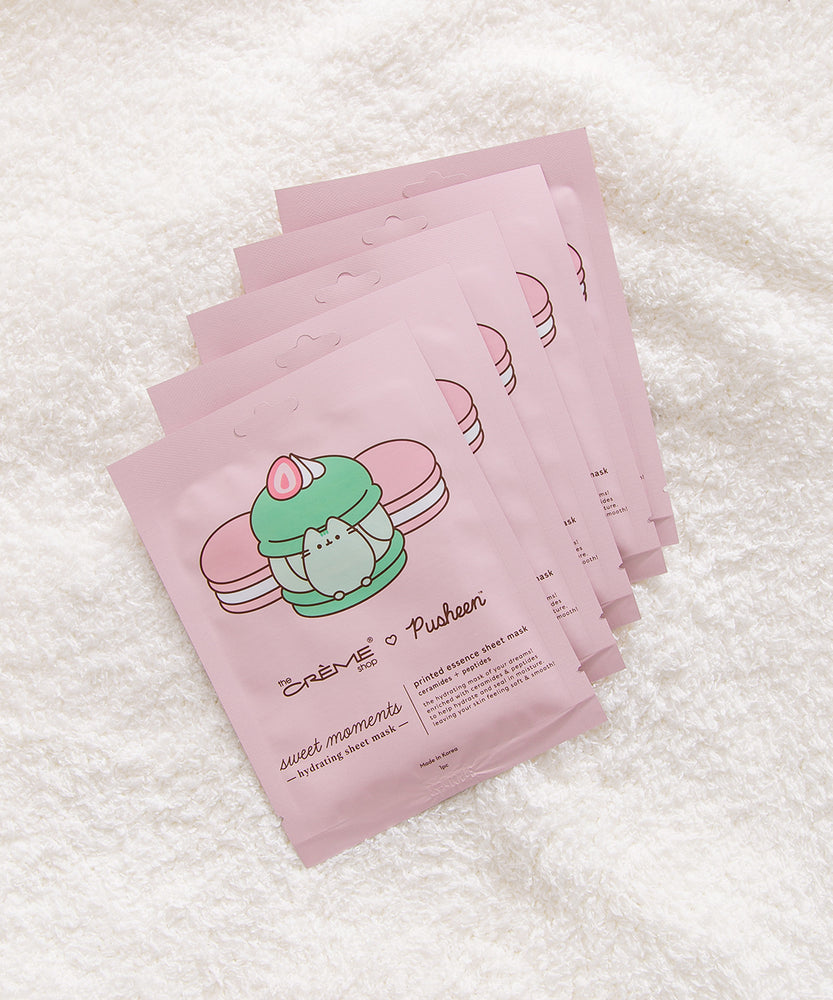 Set of five pink hydrating sheet masks laid on a white background.
