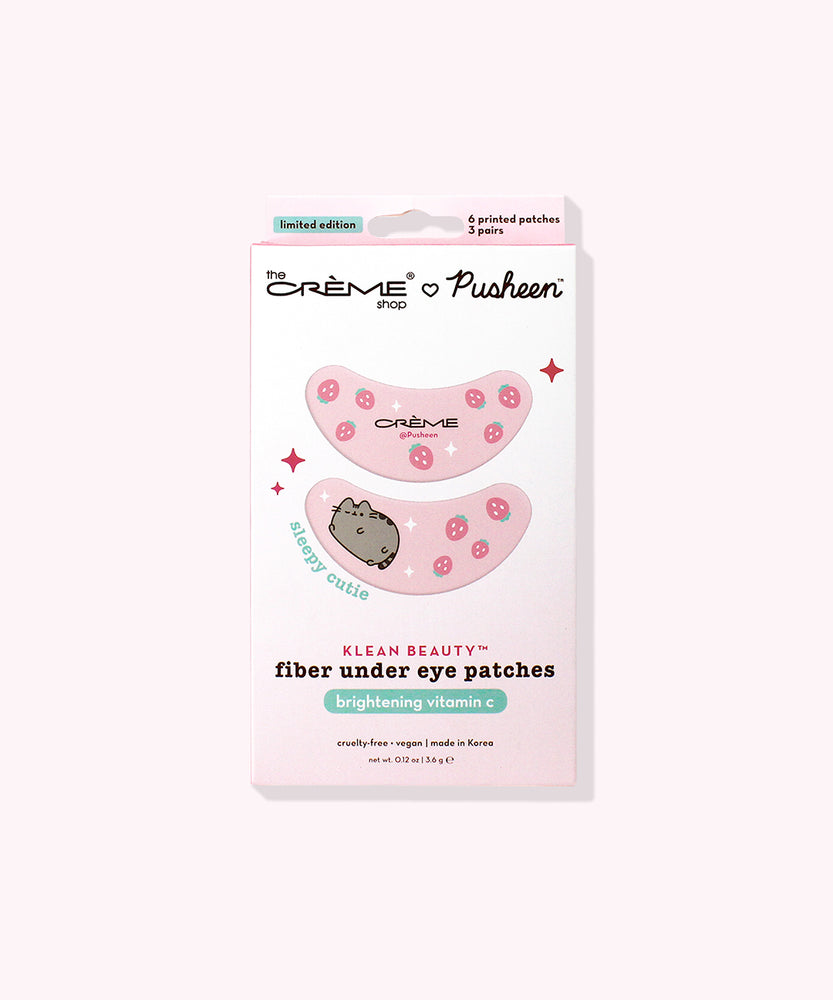 Front view of packaging of The Creme Shop x Pusheen Under Eye Patches - 3-pack. The eye patches include a graphic of Pusheen winking surrounded by pink strawberries and white sparkles.