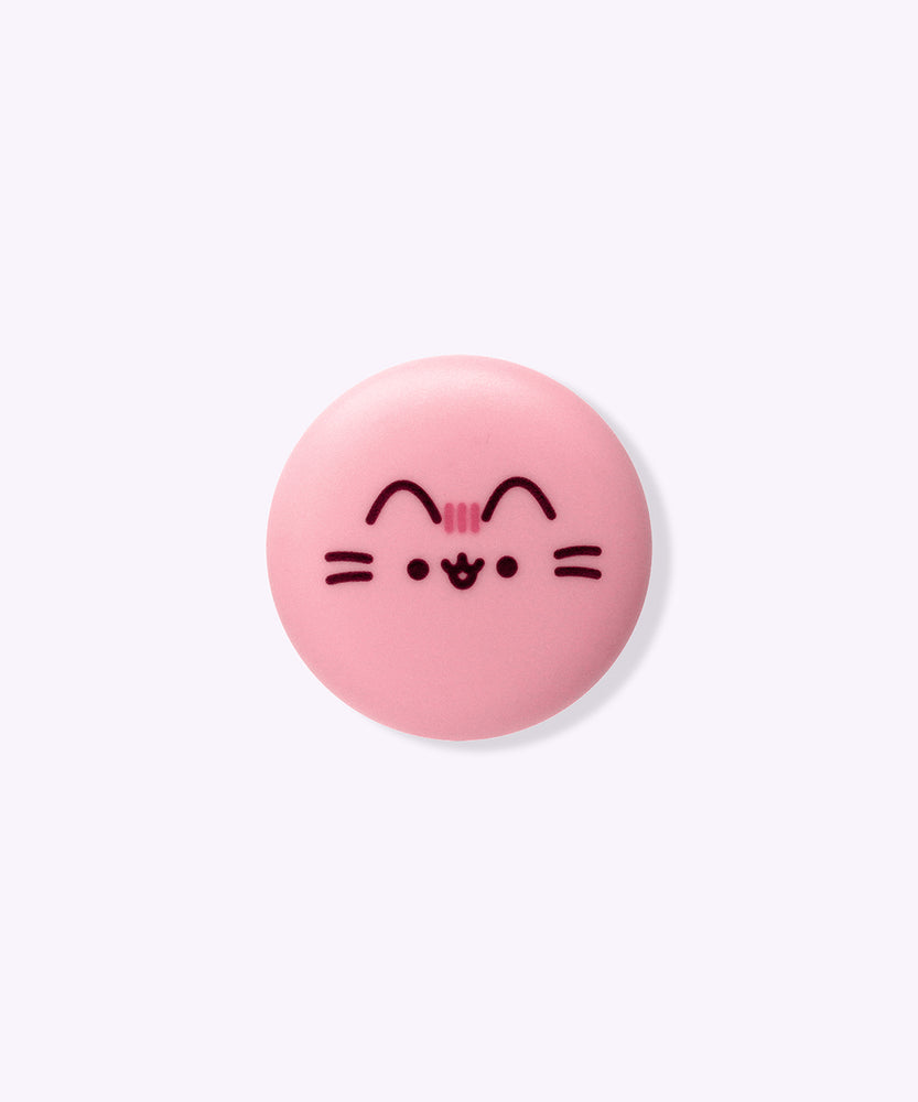 Front view of the lip balm container. The pink circular component has Pusheen's face and facial features printed in brown and pink on the front.