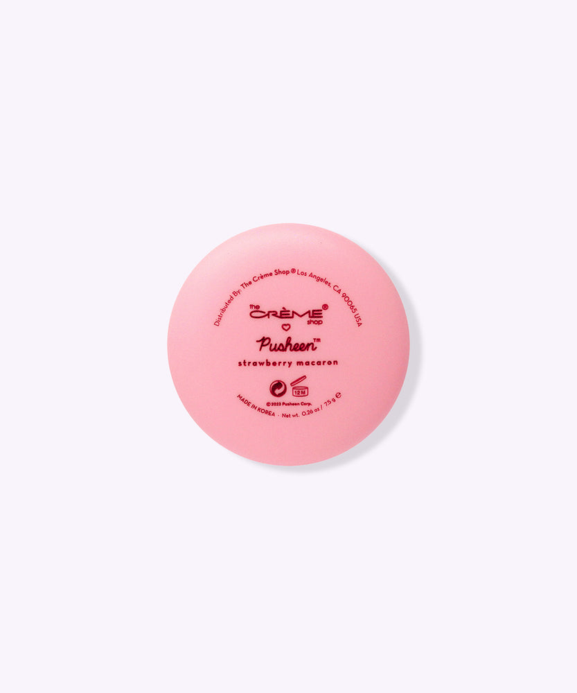 Back view of the Lip Balm component. Printed on the back are The Creme Shop and Pusheen logos as well as the product name "strawberry macaron."