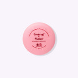 Back view of the Lip Balm component. Printed on the back are The Creme Shop and Pusheen logos as well as the product name "strawberry macaron."