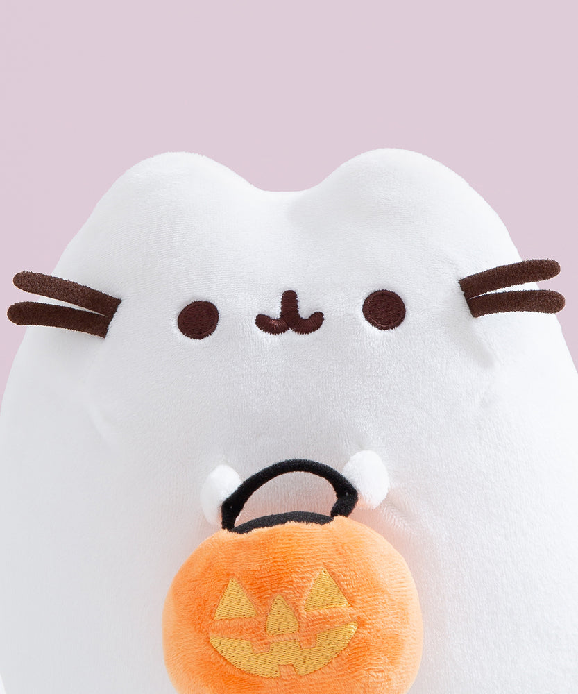 Close-up view of the Pusheen Halloween Exclusive Plush. The white ghost cat has two rounded triangle ears that extend off the top of the oval silhouette.