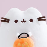 Close-up view of the Pusheen Halloween Exclusive Plush. The white ghost cat has two rounded triangle ears that extend off the top of the oval silhouette.