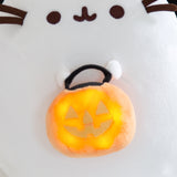 Close-up view of the light-up feature on the Halloween Cat plush. The round orange candy pail has five lights to illuminate the jack-o'-lantern trick-or-treat pail.