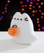 Side quarter view of the ghost plush. The rounded shape of the plush details Pusheen the Cat's classic ears but also has a ghost tail that sits out to her left side.