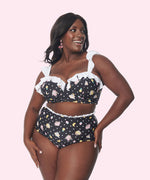 Model shows off the Pusheen Tropical Fruit Swimsuit. The black swim set features an all over print of Pusheen and Stormy with polka dots.