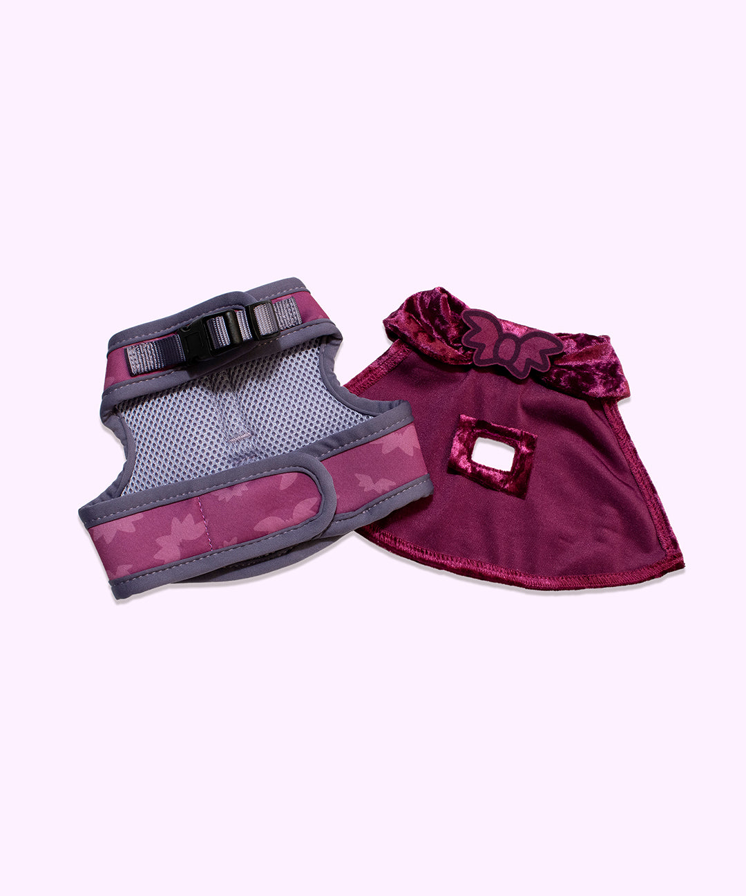 Front view of the Pusheen pet harness a cape. The purple harness is lines with grey mesh material and closes with a clasp and velcro mechanisms. The velveteen cap closes with velcro that is topped with a felt bat to cover the closure. 