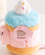 Close-up view of the Pusheen Label logo hangtags. The light pink tags feature the Pusheen the Cat logo on the circle sticker while Pusheen’s face is embossed in the rectangular shaped tag.  