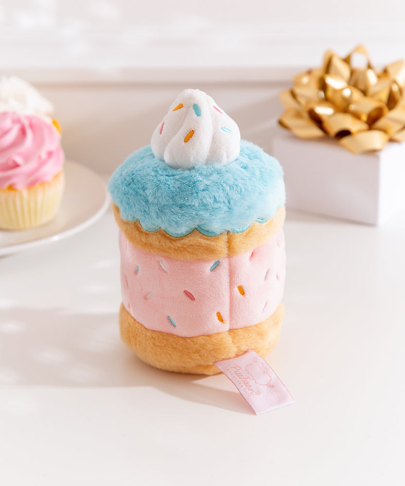 Side back view of the Pusheen Sprinkle Cake Plush. The middle cake, icing, and sprinkles embroidery continues all the way around the plush. 