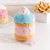 Side back view of the Pusheen Sprinkle Cake Plush. The middle cake, icing, and sprinkles embroidery continues all the way around the plush. 