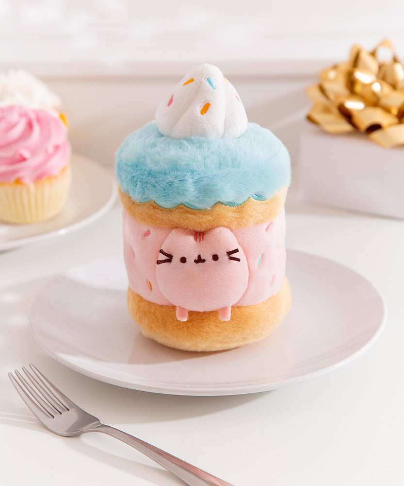 Close-up view of the Pusheen Label logo hangtags. The light pink tags feature the Pusheen the Cat logo on the circle sticker while Pusheen’s face is embossed in the rectangular shaped tag.  