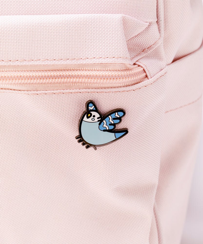 The Bo pin attached to a pink backpack.