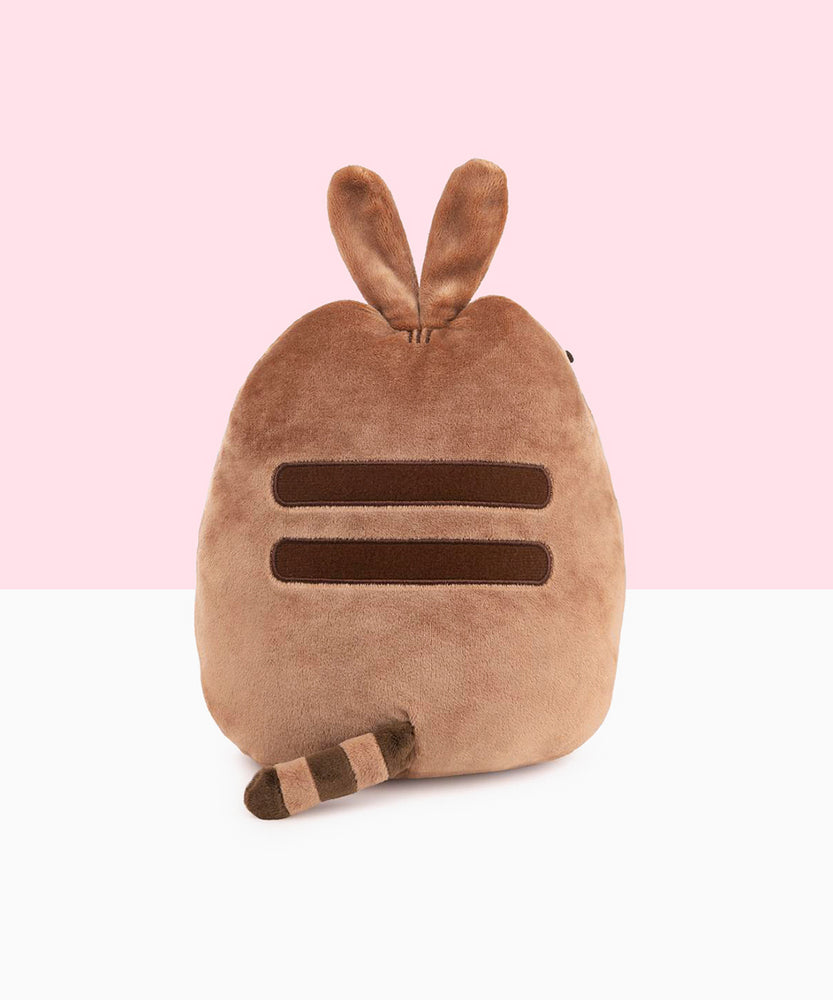 Close up of the Easter Egg Pusheen holds in her paws. The easter egg is a plush, though made of a different, smoother fabric than the rest of the Pusheen plush, the details printed directly onto the egg.