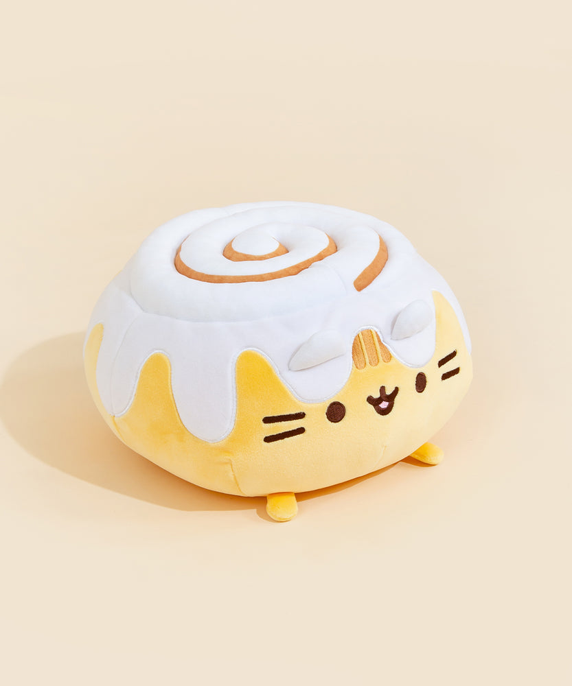 A back view of the Cinnamon Bun Squisheen, with the rim of the frosting going around the back. The plush does not have a tail. Pusheen's feet peek out from the bottom.