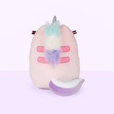 Back view of the Dreamy Pusheenicorn Squisheen in front of a light purple background. There is a multicolor mane directly behind Dreamy Pusheenicorn’s horn, colored mint, white and purple, going over Pusheen’s Back stripes and ending at the bottom stripe. Pusheen’s back stripes are embroidered in pink. Dreamy Pusheenicorn has a multicolor plush tail that matches her mane and curls around the bottom of her body to the right.