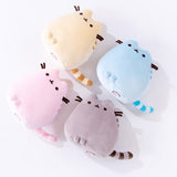 All four Mini Squisheen Plush laying on their backs on top of a white floor, the bottom of the plush partially visible. The flat bottom of the plush features two more feet and with pink paw prints embroidered into the plush.