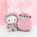 The Hello Kitty and Pusheen collaboration plush sit next to one another in front of a pink background and white and clear balloons.