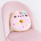 Pusheen side of the reversible Donut Plush. Pusheen’s stripes have turned pink, but she keeps her classic black eyes, nose, and whiskers while taking the form of a strawberry glazed donut. 