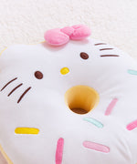 Close-up view of the Hello Kitty side of the Donut Plush. In this view, you can see the embroidered details of Hello Kitty’s facial features and her multicolored sprinkles. The sides of the donut plush are yellow.  