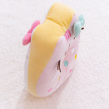 Side view of the Hello Kitty x Pusheen Donut Plush highlights the yellow sides of the plush toy that distinguishes Hello Kitty as a white glazed donut on one side and Pusheen as a pink glazed donut on the other side.  