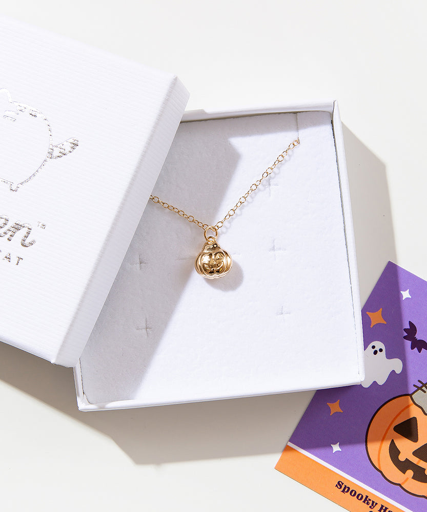 Close up of the gold charm necklace in the jewelry box