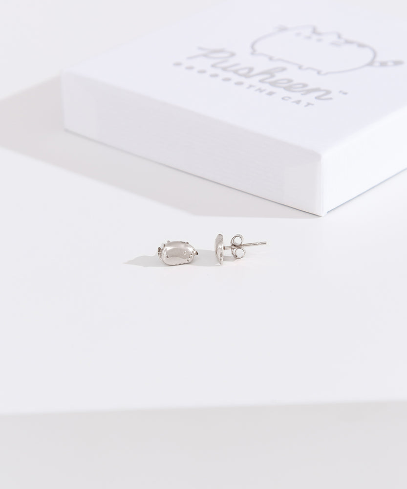 Front and side view of the Pusheen Lazy Stud Earrings in sterling silver. One earring faces forward while the other faces the side to showcase the earring bar and backer mechanism. 