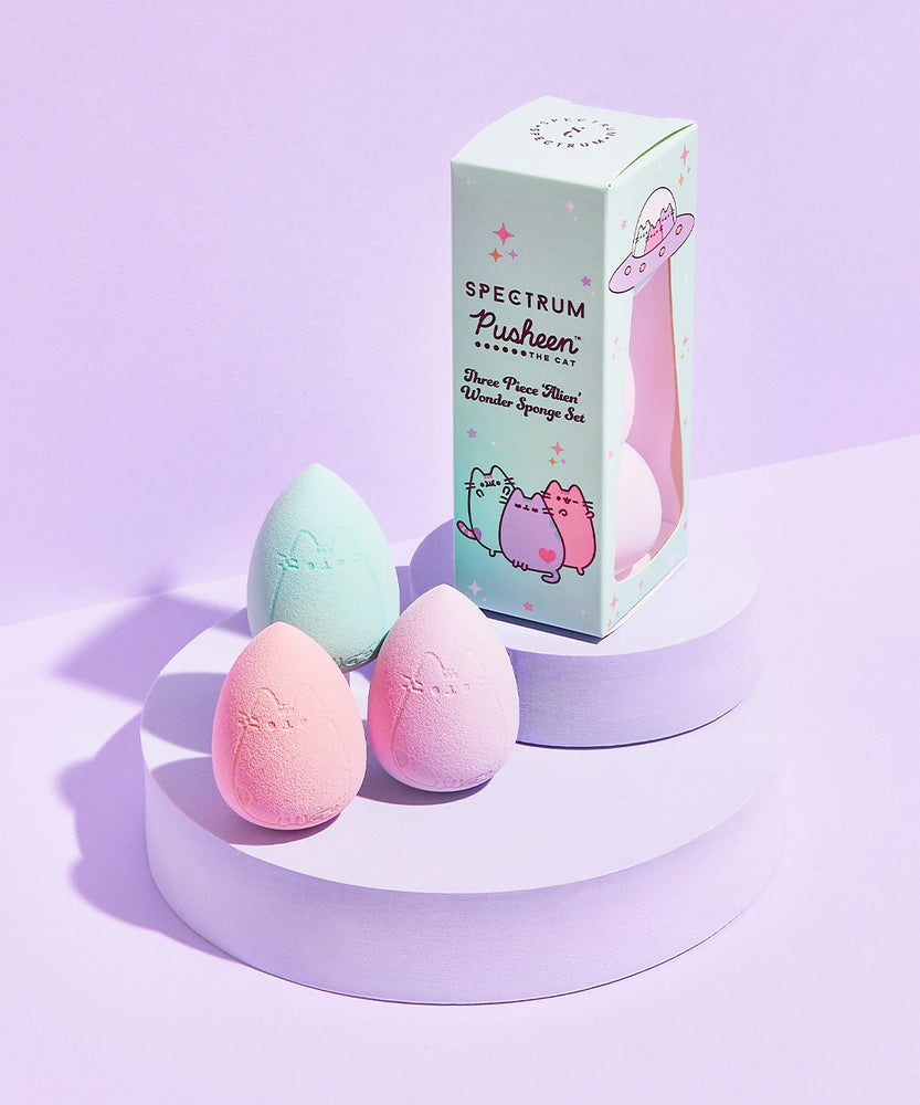 Overhead view of Pastel Pusheen 3-Piece Sponge Set. Pink, mint, and purple egg-shaped makeup sponges come in a mint green packaging box with graphic of mint, purple, and pink Pastel Pusheens. 