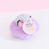 The Pastel Pusheen UFO Collector Set with all the mini plush inside the silver dome and the hangtag attached to the UFO. The hand tags include a large circular paper tag with the Pusheen the Cat logo, and a small Saturn-shaped tag on top that reads ’Includes 3 Mini Plush’.