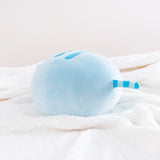 The back quarter view of the Blue Round Squisheen Plush sitting on top a fluffy white blanket. All the stripes on Blue Pusheen are a Dark Blue.