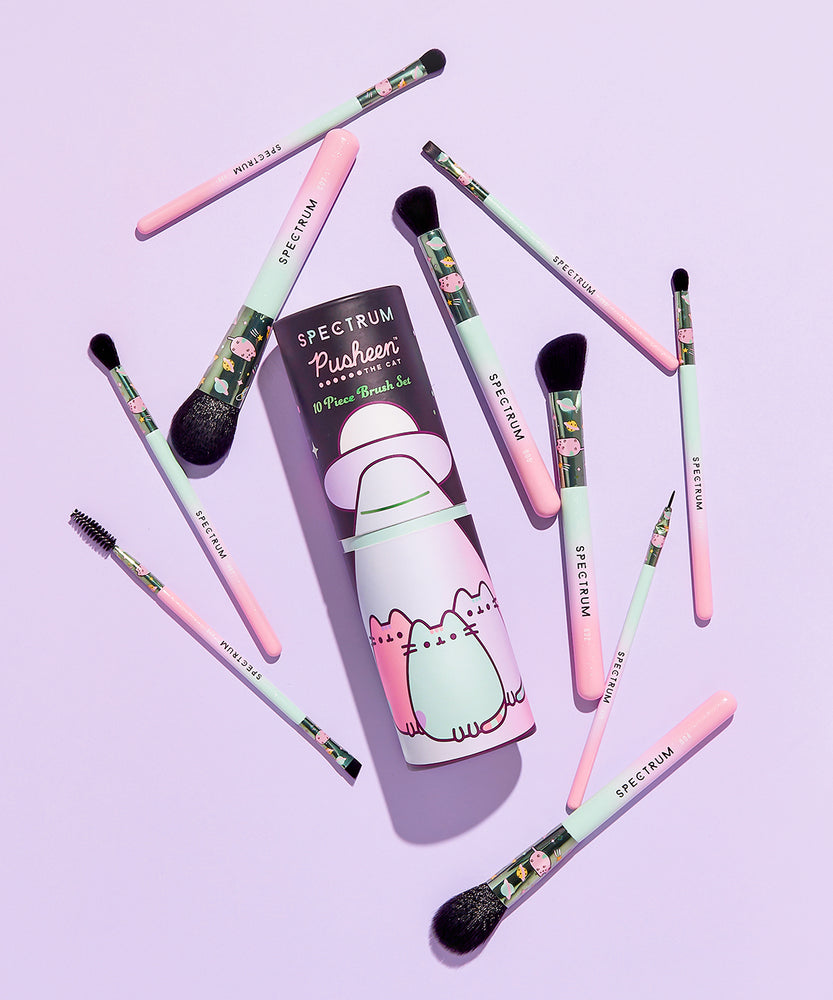 Open view of Pastel Pusheen 10-piece Makeup Brush Set in the open storage tube. The inside of the tube is mint green. The makeup brushes fit inside the tube perfectly and only the barrels and brush hairs sit out of the tube. 