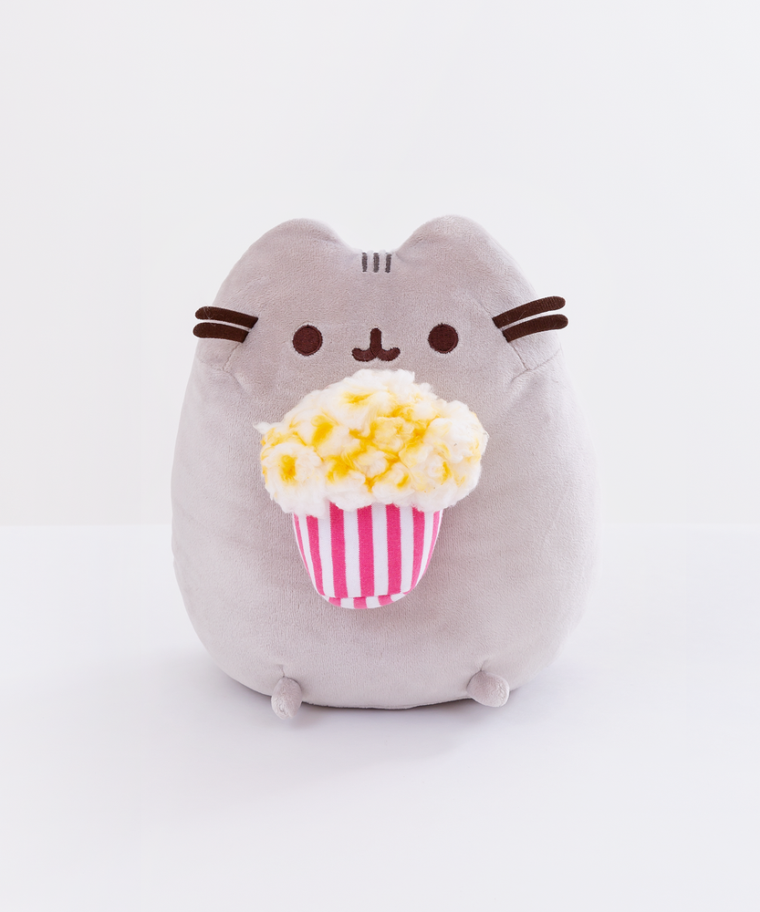 Front view of the Popcorn Pusheen Plush sitting upright in a white space.