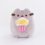 Front view of the Popcorn Pusheen Plush sitting upright in a white space.