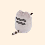 Back view of the plush shows Pusheen’s classic back stripes and striped grey tail.