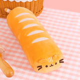 Top view of the bread plush. The golden-colored plush has five light cream lines across the top of the plush body to mimic bread bake lines. 
