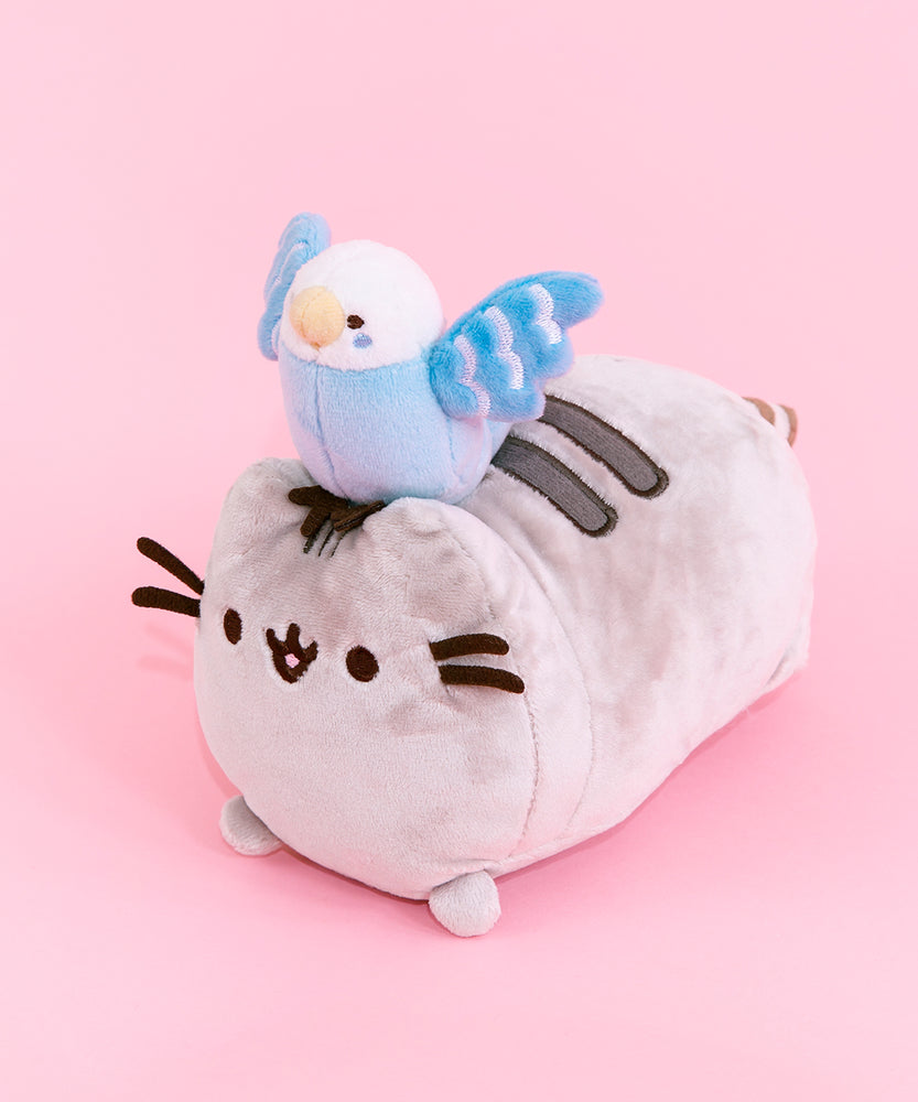 Full quarter view of the Bo and Pusheen plush in front of a pink background.
