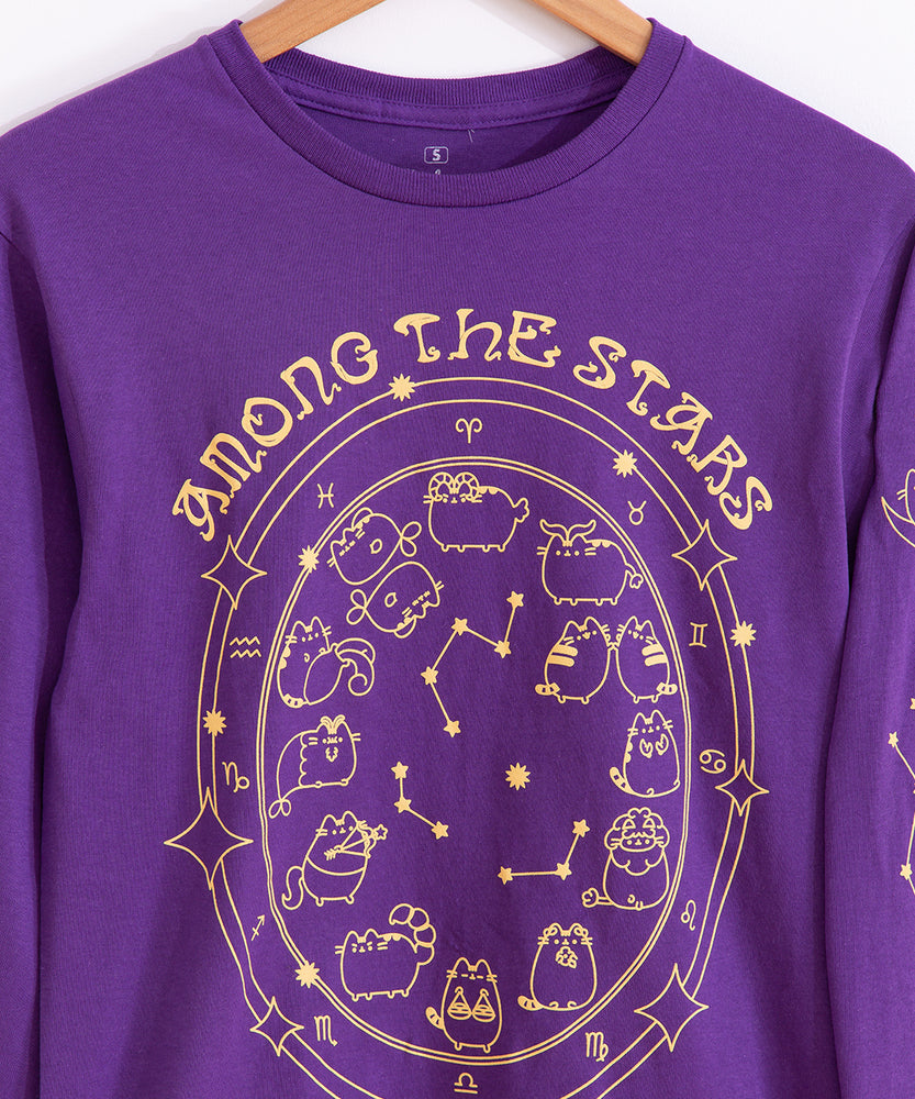 Close-up view of Pusheen celestial graphic tee. The astrological chart features Pusheen as the zodiac signs, star constellations, and stars. Above the zodiac chart, is the phrase “Among the Stars.” 