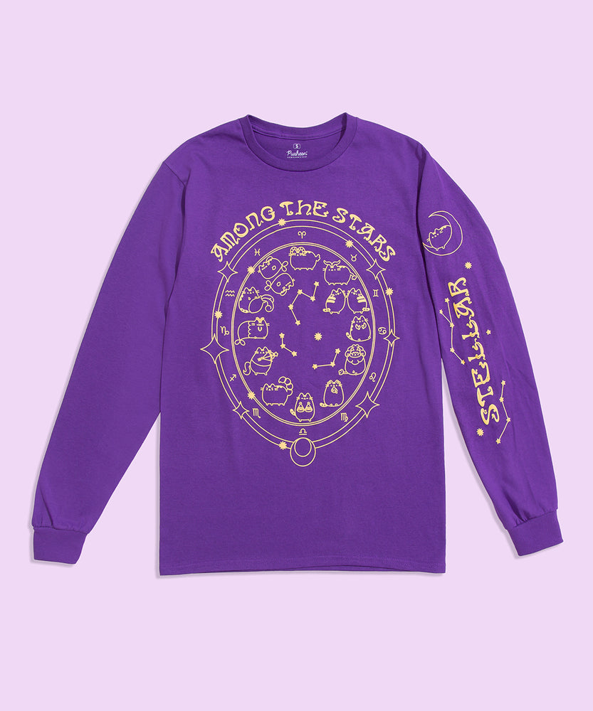 Front view of the Pusheen Celestial Long-Sleeve Tee. The purple graphic t-shirt is in front of a light-purple colored background. In this view, the large front graphic of Pusheen as the zodiac signs and the printed graphic detail down the sleeve can be seen. 