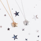 Front view of Pusheen Celestial Charm Necklace. On the left is the gold vermeil finish of the charm necklace and on the right is a sterling silver finish. The necklace shows Pusheen the Cat holding an enlarged star in front of her body. 