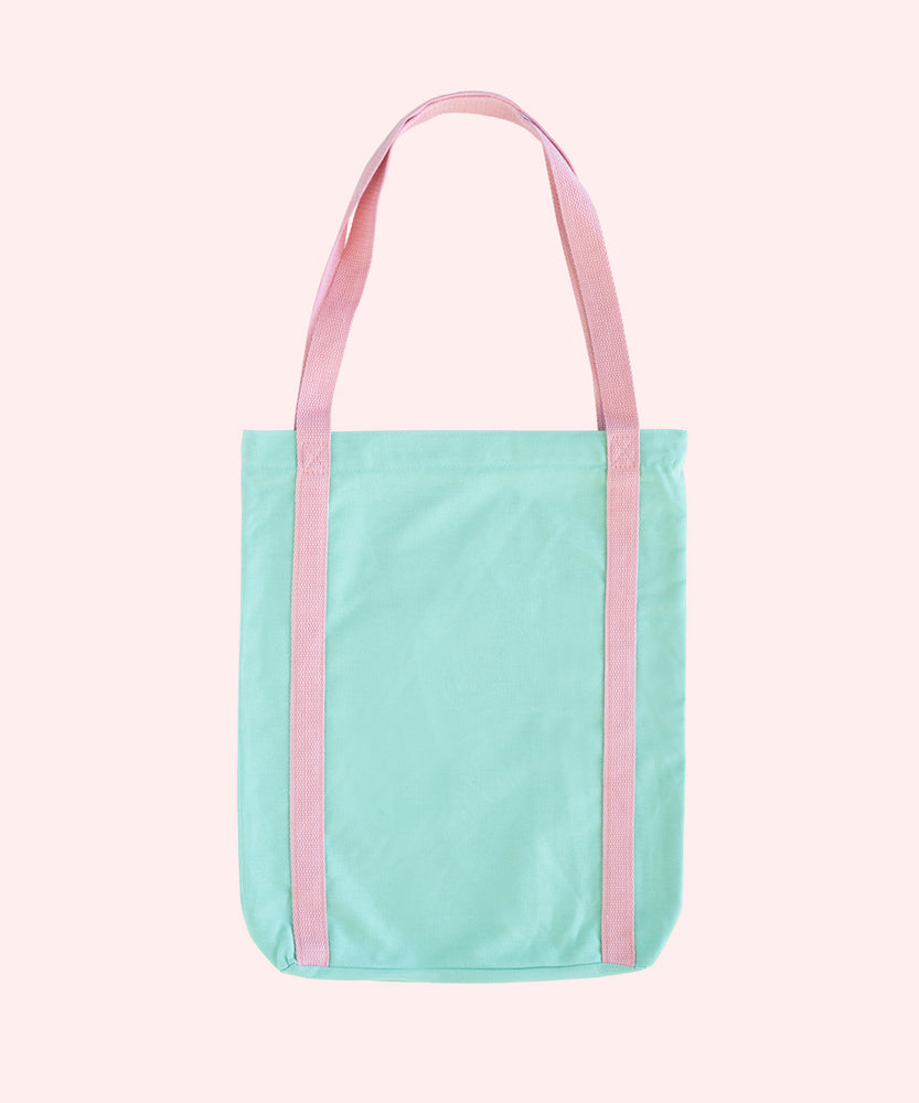 Back view of Pusheen Deluxe Tote Bag. The mint tote bag has pink handles that extend down the entire body of the bag. 