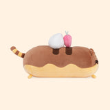 Side view of the Pusheen Éclair Plush shows the bottom portion of the plush shown in a creamy yellow color. A dollop of whipped cream and light pink strawberry plush sit atop the classic French dessert.