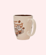 Close-up view of the handle on the Pusheen Espresso Yourself Mug. This back graphic peaks out of the side of the handle, indicating that this mug has Pusheen, Pip, and Stormy graphics on both sides of the tan mug.  