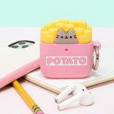 Front view of the Pusheen French Fries Airpods Case placed on a notebook surrounded by an iPhone, pencil, Apple Airpods. 